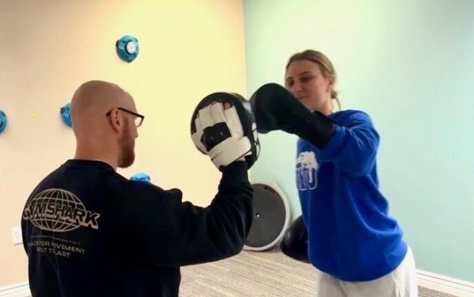woman boxing in clinical setting